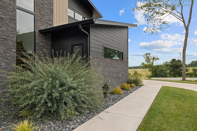 view of side of home with stone siding