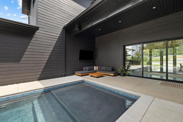 view of pool with a patio and an outdoor living space