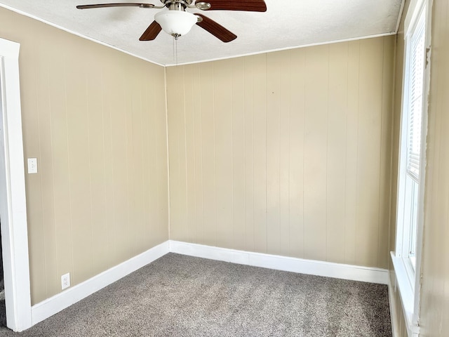 spare room with ceiling fan and carpet flooring