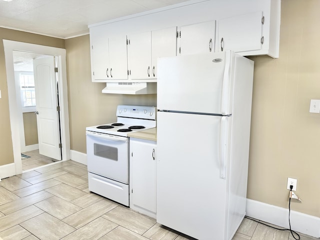 kitchen with white appliances, ornamental molding, and white cabinetry