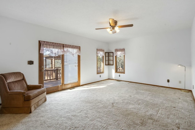 unfurnished living room with ceiling fan and carpet floors