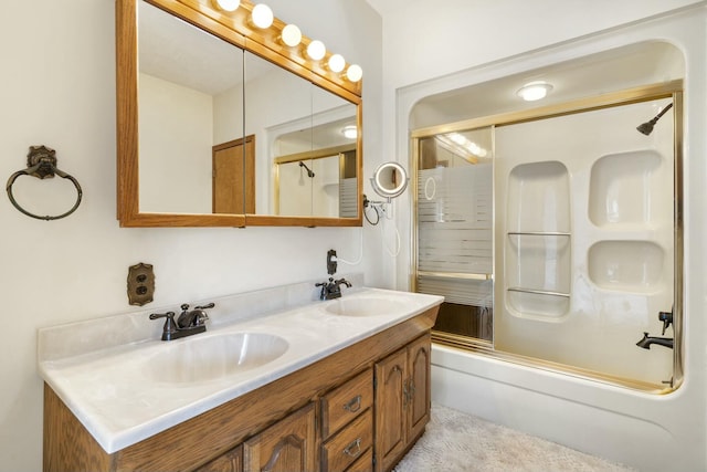 bathroom featuring bath / shower combo with glass door and vanity