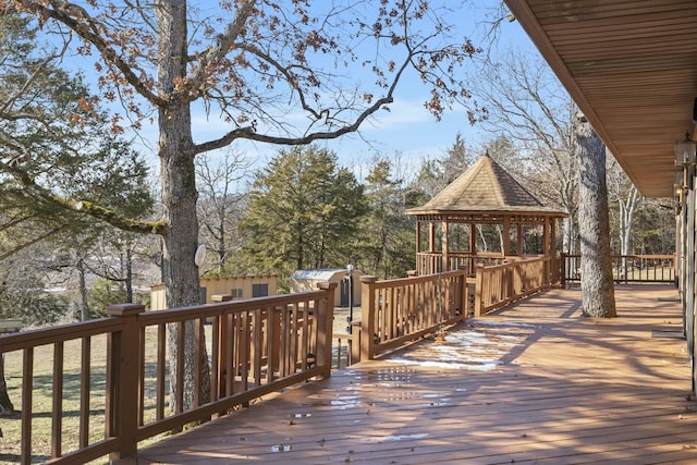 wooden terrace featuring a gazebo