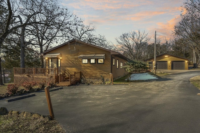 view of front of house with a deck, an outbuilding, and a garage