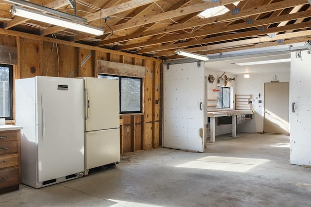 interior space with white fridge and plenty of natural light