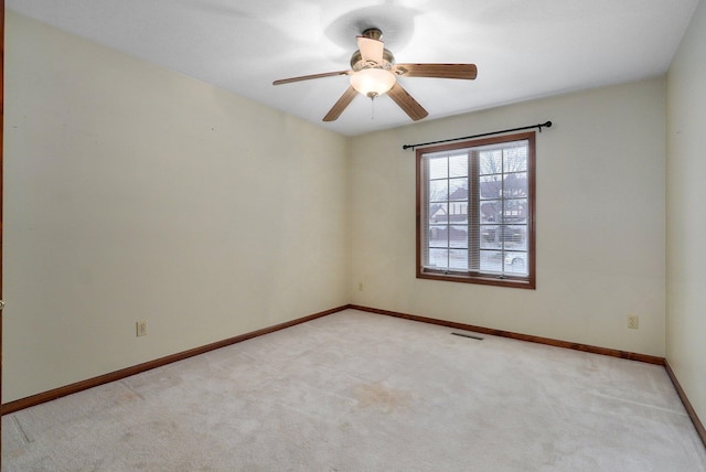 unfurnished room featuring ceiling fan and light carpet