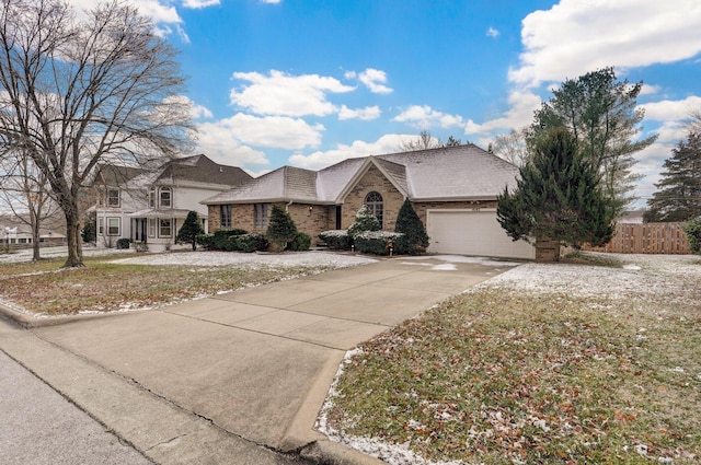 single story home with a front yard and a garage