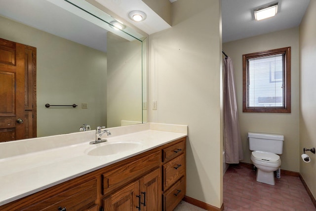 bathroom featuring toilet, vanity, and curtained shower