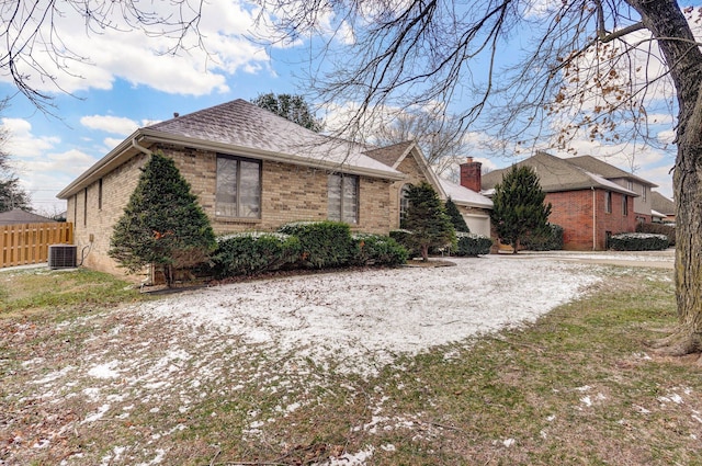 view of side of property featuring central AC