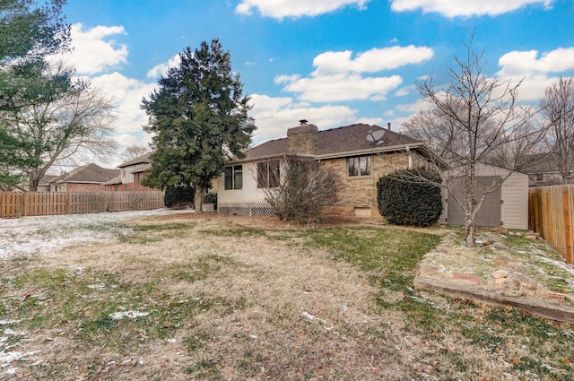 rear view of house featuring a yard