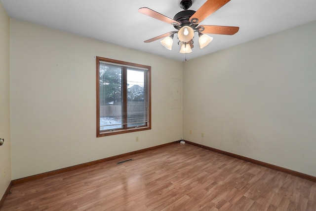 spare room with ceiling fan and light wood-type flooring