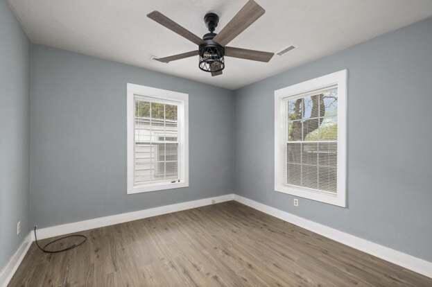 spare room featuring hardwood / wood-style flooring and ceiling fan