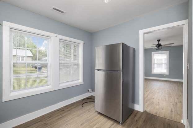 kitchen featuring ceiling fan, stainless steel fridge, and hardwood / wood-style flooring