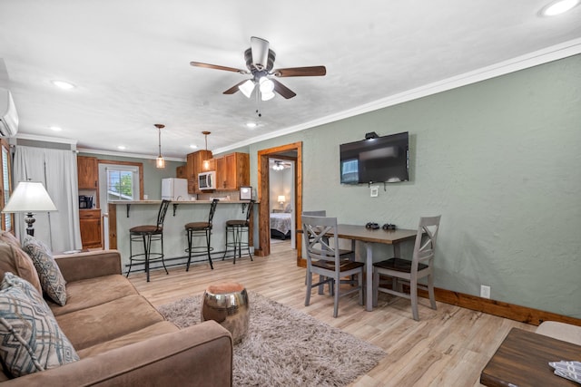 living room with ceiling fan, a wall mounted air conditioner, crown molding, and light hardwood / wood-style floors