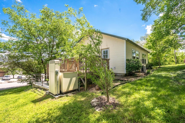 view of home's exterior with central AC unit and a yard