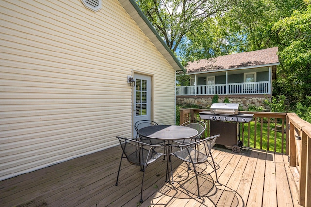 wooden terrace featuring grilling area