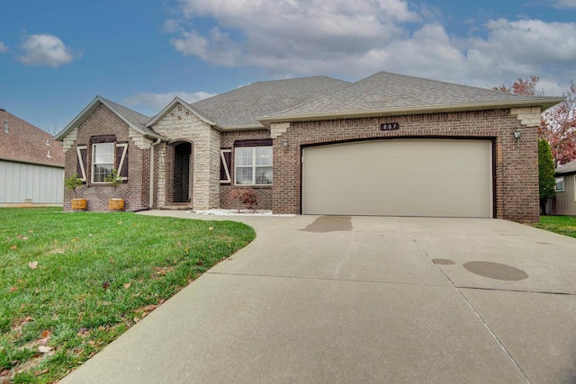 view of front of home with a front lawn and a garage