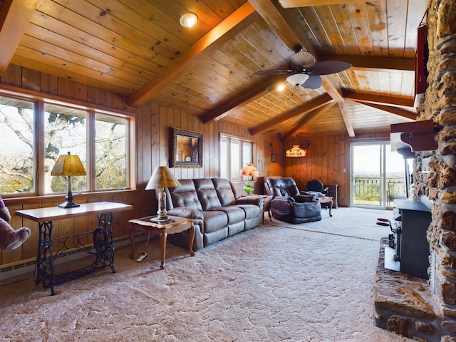 living room with carpet, a wood stove, ceiling fan, lofted ceiling with beams, and wood ceiling