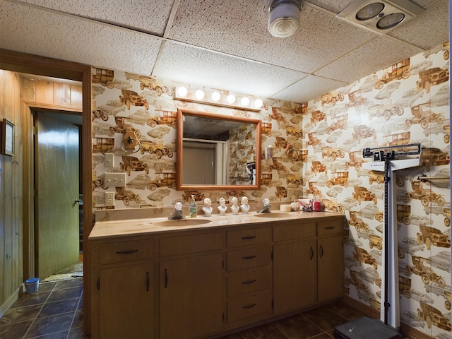 bathroom with a paneled ceiling and vanity