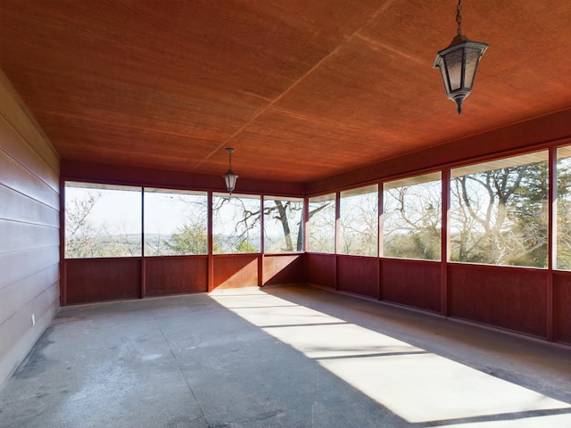 unfurnished sunroom with wooden ceiling and a healthy amount of sunlight