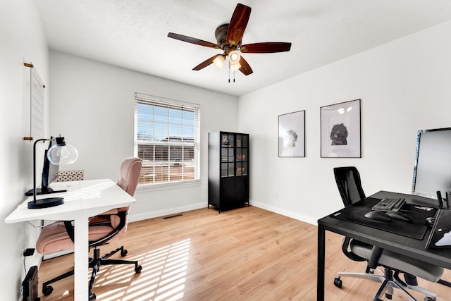 office with ceiling fan, a textured ceiling, and light hardwood / wood-style flooring