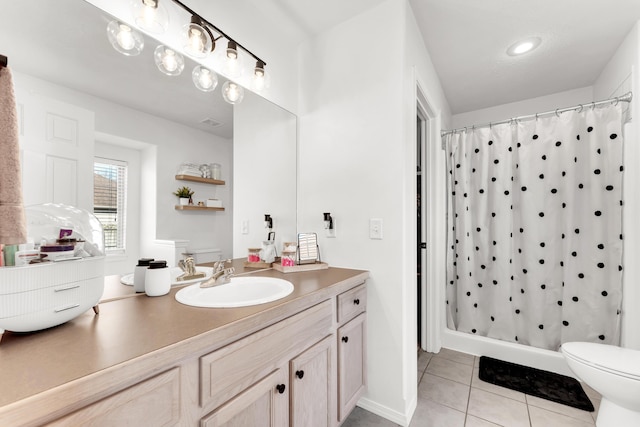 bathroom with toilet, tile patterned flooring, vanity, and curtained shower