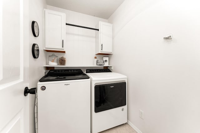 washroom with cabinets, light tile patterned flooring, and separate washer and dryer