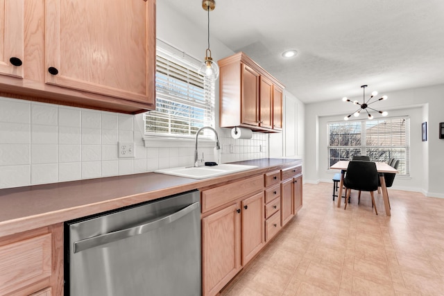 kitchen with backsplash, dishwasher, a notable chandelier, sink, and hanging light fixtures