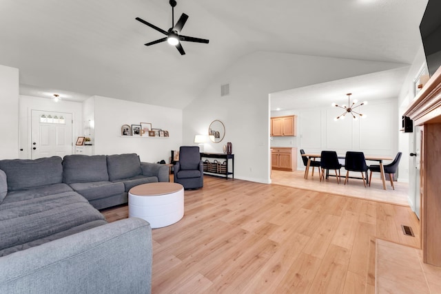 living room featuring light hardwood / wood-style floors, high vaulted ceiling, and ceiling fan with notable chandelier