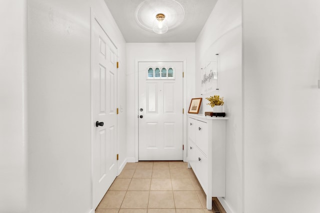 entryway with light tile patterned floors