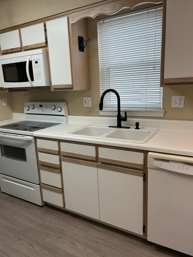 2529 State Highway 176 Unit 5, Rockaway Beach, MO 65740 - kitchen featuring white appliances, white cabinetry, light countertops, and wood finished floors