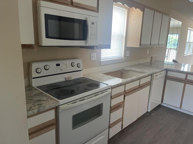 2529 State Highway 176 Unit 5, Rockaway Beach, MO 65740 - kitchen with white appliances, healthy amount of natural light, white cabinets, and dark wood-type flooring