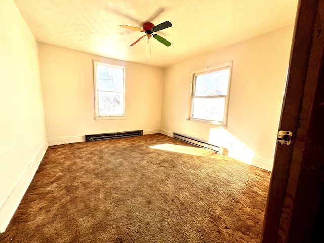 empty room with ceiling fan, carpet floors, and a baseboard heating unit