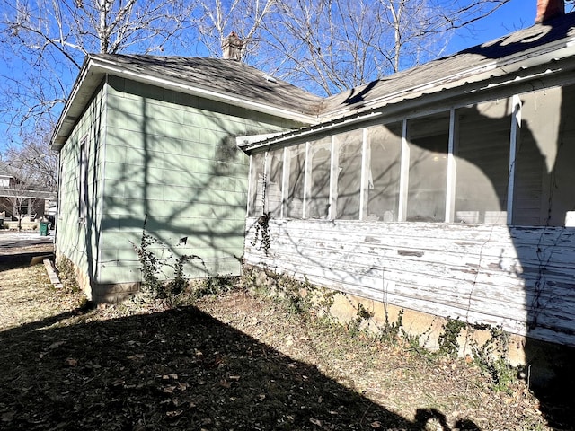 view of side of home featuring a sunroom