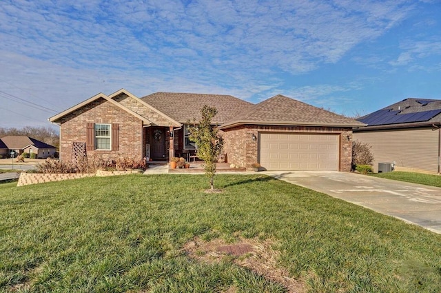 ranch-style house featuring central AC, a front lawn, and a garage