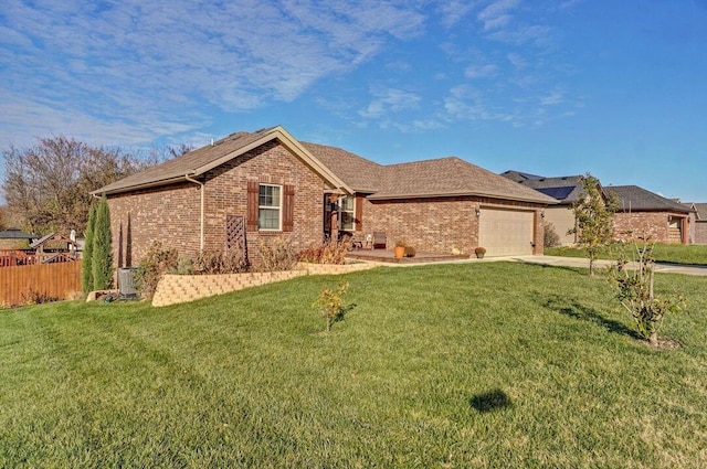 view of front of home with a garage and a front lawn