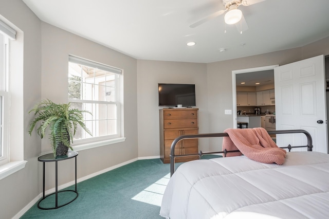 carpeted bedroom featuring ceiling fan and multiple windows