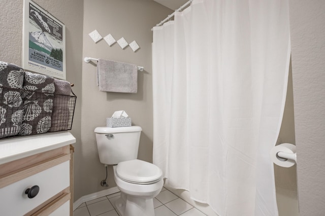 bathroom with tile patterned flooring and toilet