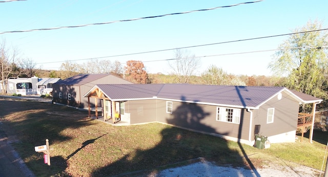 rear view of property featuring a yard