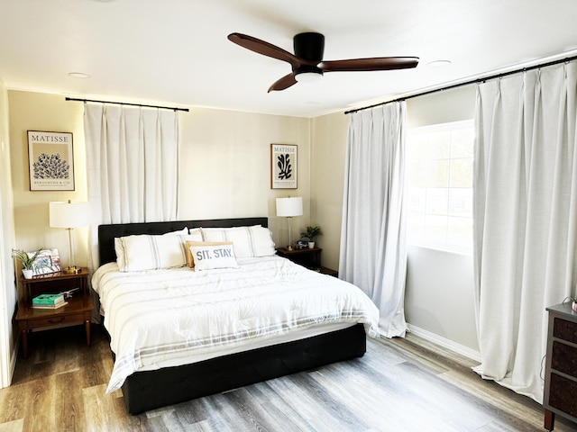 bedroom featuring hardwood / wood-style floors and ceiling fan