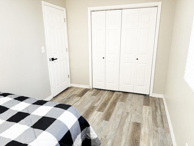 unfurnished bedroom featuring a closet and light hardwood / wood-style flooring