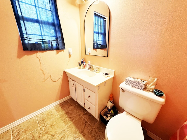 bathroom featuring toilet and vanity