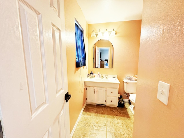 bathroom featuring toilet and vanity