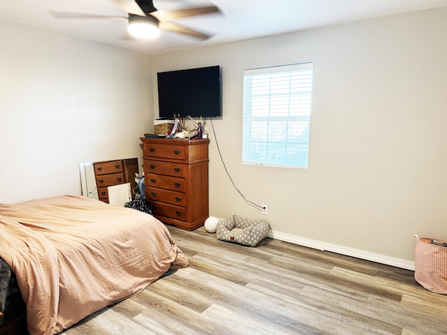 bedroom with ceiling fan and wood-type flooring