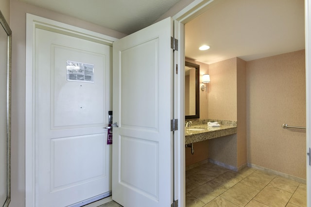 entryway featuring built in desk and light tile patterned floors