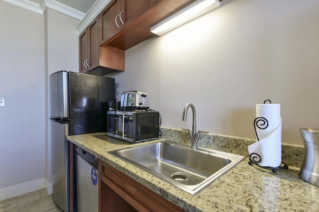 kitchen featuring light tile patterned floors, appliances with stainless steel finishes, crown molding, and sink