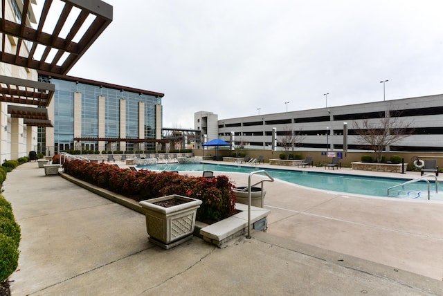 view of swimming pool featuring a pergola and a patio