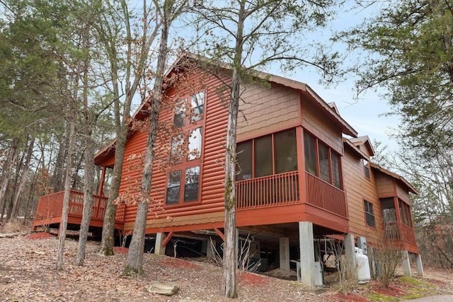 back of house featuring a sunroom