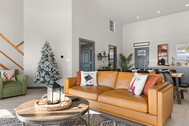 tiled living room with a high ceiling