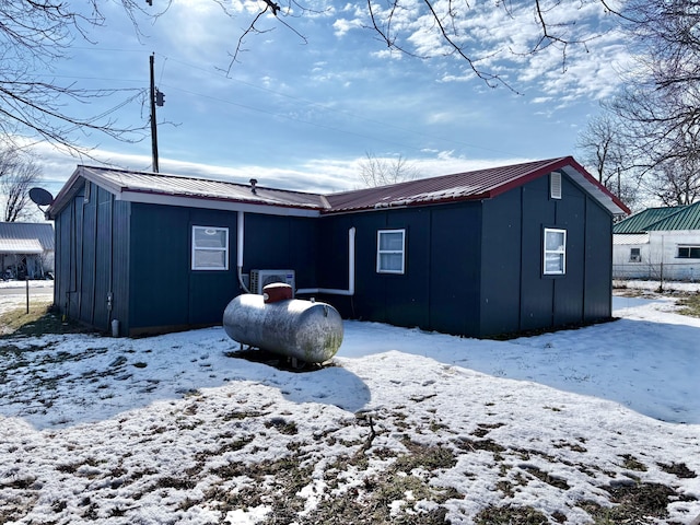 view of snow covered rear of property